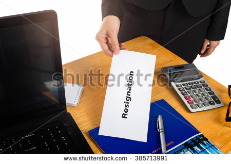 stock-photo-hand-holding-resignation-letter-on-the-desk-of-the-boss-385713991